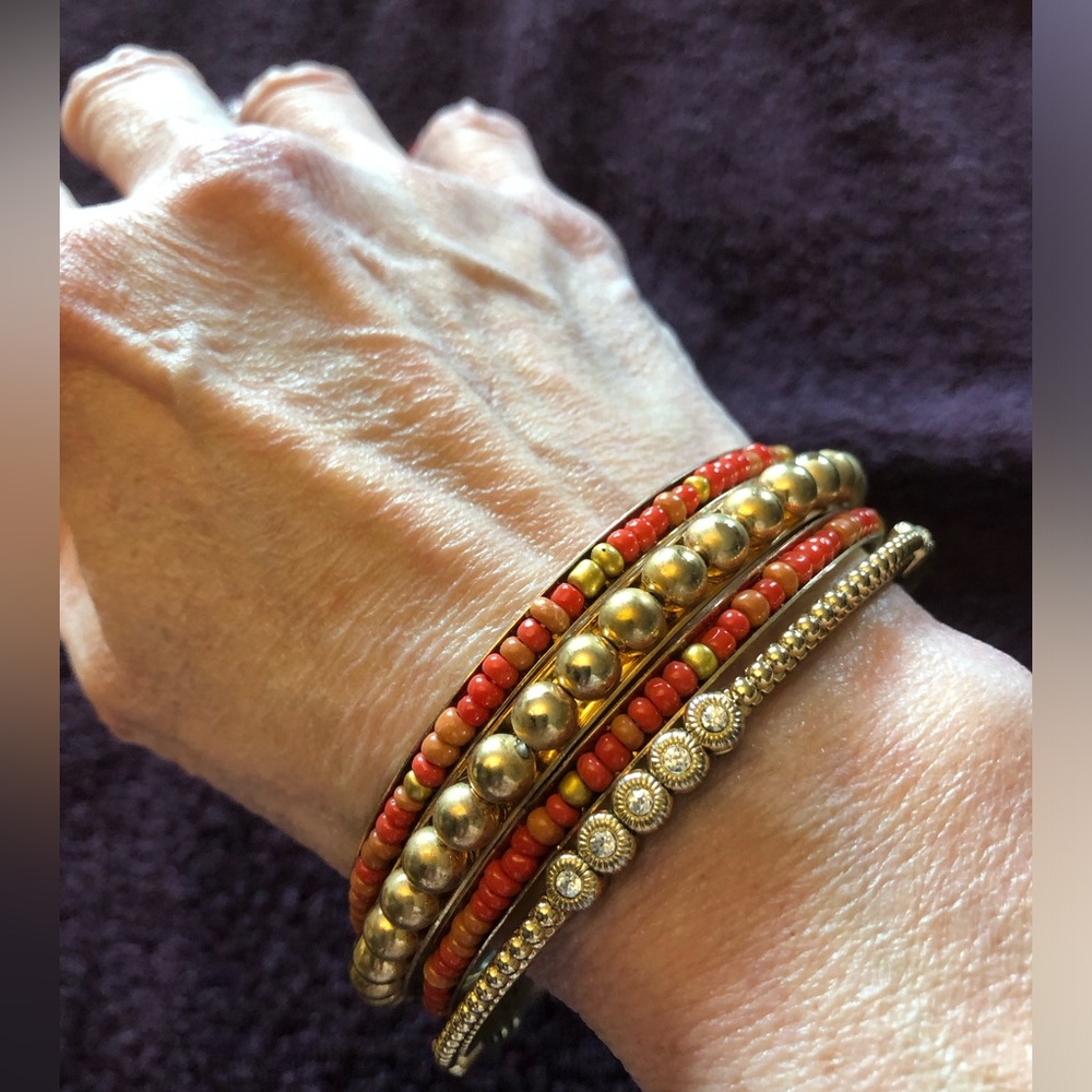 Set of 4 gold tone fashion bangle bracelets